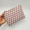 Handheld view of a large checkerboard knit makeup bag in purple and yellow colors - Purple Plaid