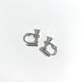Close-up of silver screw-back earring converters for non-pierced ears on white background - Silver Spiral Screw Earring Converter