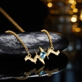 Golden S925 silver necklace with heartbeat pendant and blue topaz on black stone - Gold Natural Topaz Necklace