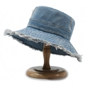 Retro washed blue denim bucket hat with distressed frayed edges on a wooden stand - One Size / Blue 1