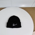 Close-up of black knit beanie featuring white Pensacola cursive letter embroidery - One Size (3-8 Years) / Black