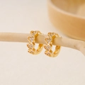 Elegant gold-plated heart-shaped huggie earrings with cubic zirconia on a wooden display - EH411020