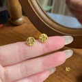 Vintage style gold coin stud earrings with embossed texture shown on fingertips - Old Coin Relief Shape