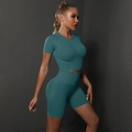 Detail view of seamless dark teal yoga set showing high waist band and ribbed texture - Blue