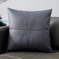 Gray faux leather cushion cover with cross-stitch detailing on dark sofa - Gentleman Grey