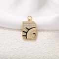 Macro shot of gold tarot rectangle pendant with zircon inlay and black enamel finish - Black Enamel Pattern Gold