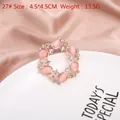 Pink cat eye stone floral wreath brooch with rhinestones in rose gold finish - Round Pink Cat's Eye Wreath