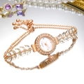 Elegant rose gold women's quartz watch with crystal leaf bracelet and green dial - White