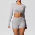 Detail of high-stretch light grey yoga set featuring cropped long sleeve and high waist shorts - Frost Grey