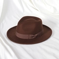 Detailed view of dark brown felt fedora hat with satin ribbon and bow on silk fabric - 58cm (Adult) / Coffee