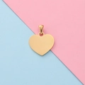 Close-up of heart-shaped gold stainless steel pendant with a polished mirror finish - Gold