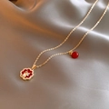 Detail of Christmas necklace with red clover pendant, golden reindeer and white pearl - Gold Dragon Clover Reindeer Necklace