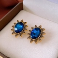 Macro detail of vintage gold earrings featuring oval blue gemstones and floral petal design - Sunflower Deep Blue Gemstone Studs (20#)