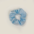 Macro view of light blue satin scrunchie showing glossy fabric texture and pleats - Satin 26 (Sky Blue)