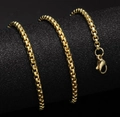 Gold stainless steel beaded chain necklace with lobster clasp on a black display - Chain / Gold