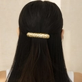 Detail of golden hammered metal hair clip on long black hair with textured finish - Gold Hammered Clip (0567)