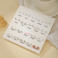 Lot de 20 paires de boucles d'oreilles argentées avec perles et diamants sur carte - E1946-1