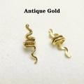 Detailed view of two antique gold spiral snake pendants for DIY hair accessories - Antique Gold