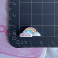 Close-up of small rainbow cloud resin accessory with ruler showing 2cm width scale - Smiling Cloud Rainbow