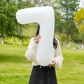 Outdoor photo of a white 32-inch number 7 foil balloon for birthday party decor - Number 7 / White