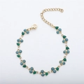 Detail showing the 18k gold chain, lobster clasp, and blue glitter cherry pendant - Gold + Blue