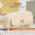 Creamy white high-capacity canvas pencil case with button flap and 210mm length - Off White