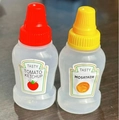 Mini plastic squeeze bottles with red and yellow caps for tomato ketchup and mustard - Tomato & Mustard (Spanish Label)