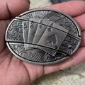 Detailed close-up of antique silver belt buckle featuring embossed poker ace cards - Poker Ace
