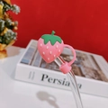 Detail of pink strawberry silicone straw cover on a clear glass drinking straw - Pink Strawberry Straw Cover