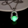 Luminous green dragon claw pendant necklace glowing intensely against a dark background - Green