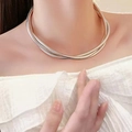 Close-up of triple-strand bicolor metal snake chain necklace on model neck - Silver Wound Necklace