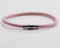 Detailed view of pink leather bracelet with a silver magnetic clasp on grey background - Pink