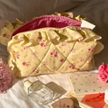 Quilted floral makeup bag in yellow with pink flowers and ruffled edge detail - Yellow Rose Ruffle Style