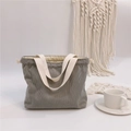 Detail of grey corduroy drawstring handbag with cream-colored woven fabric handles - Light Gray