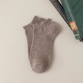 Brown cotton athletic short socks with ribbed cuffs on a vintage beige background - One Size / Light Coffee