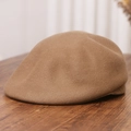 Macro shot of dark camel wool felt beret showing thick texture on a wooden desk - M (56-58cm) / Camel