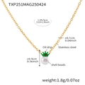 Detail of golden crown pendant necklace featuring green oil drip and white shell beads - Necklace / 35+5CM
