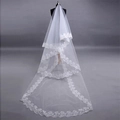 Three-meter white bridal veil with intricate computer-embroidered lace edge on a model - Milky White