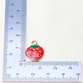 Detailed strawberry pendant charm size measurement on white fabric with a ruler - Style 5