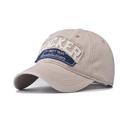 Detail of khaki cotton baseball cap featuring vintage Docker embroidery and washed fabric - Rocker Beige