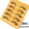 Detail view of 5 pairs of layered fox-eye false eyelashes on a gold wavy tray - ZB51 Cotton Band / 5 Pairs Set