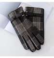 Detailed close-up of British plaid gloves with brown wool fabric and black leather wrist strap - Black Brown Plaid