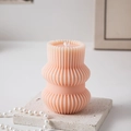 Pale pink geometric pillar candle with ribbed texture on a white stone pedestal - Origami Geometric Type I / Soft Pink