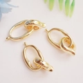 Three 14K gold-filled heart oval clasps for DIY jewelry making on beige fabric - Oval Clasp 14K Gold
