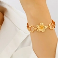 Textured gold floral charm bracelet with hollow design worn on a female wrist - Gold Mixed Style Flower Bracelet (8961)