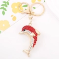 Detailed view of a golden dolphin keychain with red and white sparkling crystals - Dolphin 4 (Red)