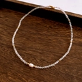Close-up of baroque pearl and moonstone beads on a seaside style necklace - Necklace / White
