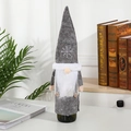 Grey Christmas gnome wine bottle cover with snowflake embroidery and plush white beard - Gray