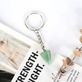 Detail shot of a hexagonal polished green aventurine crystal pendant on a silver keychain - Green Aventurine