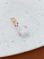 Detail of pink and white snowman charm with glossy enamel finish and golden metal ring - Pink Rounded Snowman Pendant